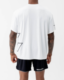 Back view of the Nexletica Perform Hybrid Oversized T-Shirt in black with the NEXLETICA sleeve wordmark and outlined logo graphic