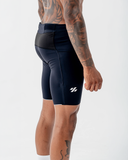 Back view of the black Nexletica Men's Perform Running Tights showing the mesh waistband panel, rear zip pocket and reflective hem trim