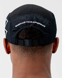 Close-up back view of the black Nexletica Perform Hat showing the adjustable clip strap and one-size fit