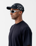 Front-on view of the black Nexletica Perform Hat worn with sunglasses, showing the NEXLETICA branding