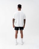 Full-length back view of the Nexletica Perform Hybrid Oversized T-Shirt in black with matching NEXLETICA shorts and socks