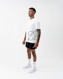 Full-length side view of the black Nexletica Perform Hybrid Oversized T-Shirt styled with shorts and trainers, showing the relaxed oversized fit