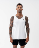 Man wearing the Nexletica Men's Perform Running Singlet in white, front view, with the black logo emblem on the chest