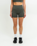 Front view of model wearing Nexletica Synergy Shorts in Khaki
