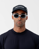 Angled side view of the black Nexletica Perform Hat showing the mesh panels and breathable build